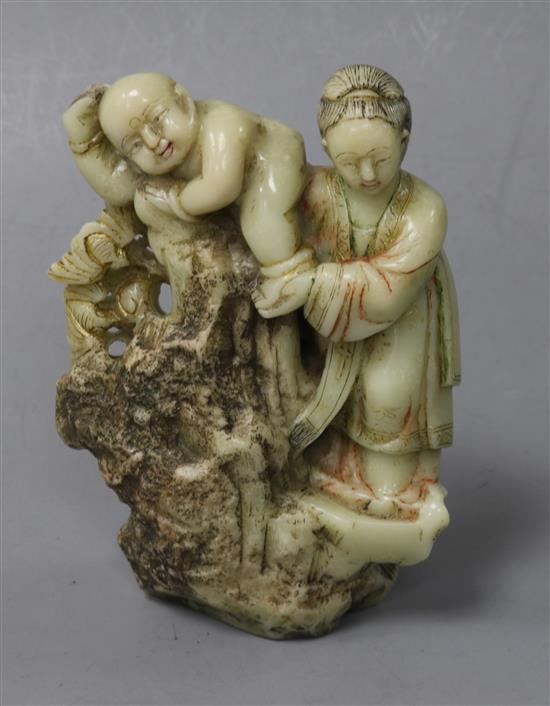 A Chinese export polychrome soapstone group of a mother and child, probably 18th century, height 11.5cm